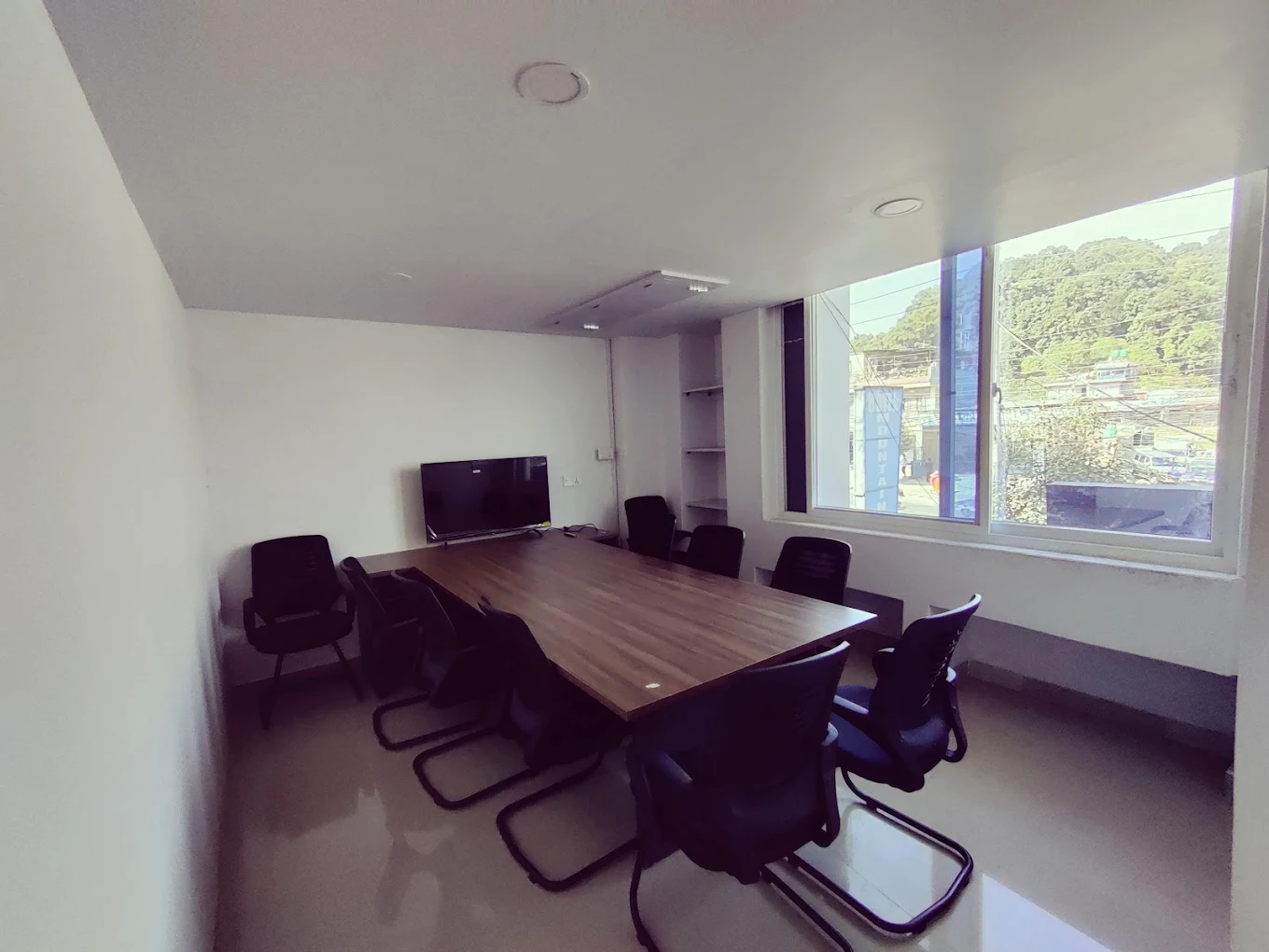 Jyaba Academy training room in Pokhara - modern classroom with conference table and presentation screen